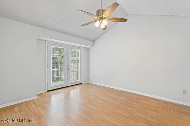 a view of empty room with wooden floor