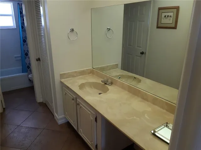 a bathroom with a granite countertop sink