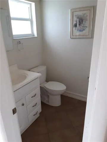 a bathroom with a toilet sink and vanity
