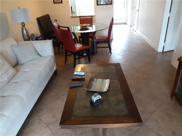 a living room with furniture rug and wooden floor
