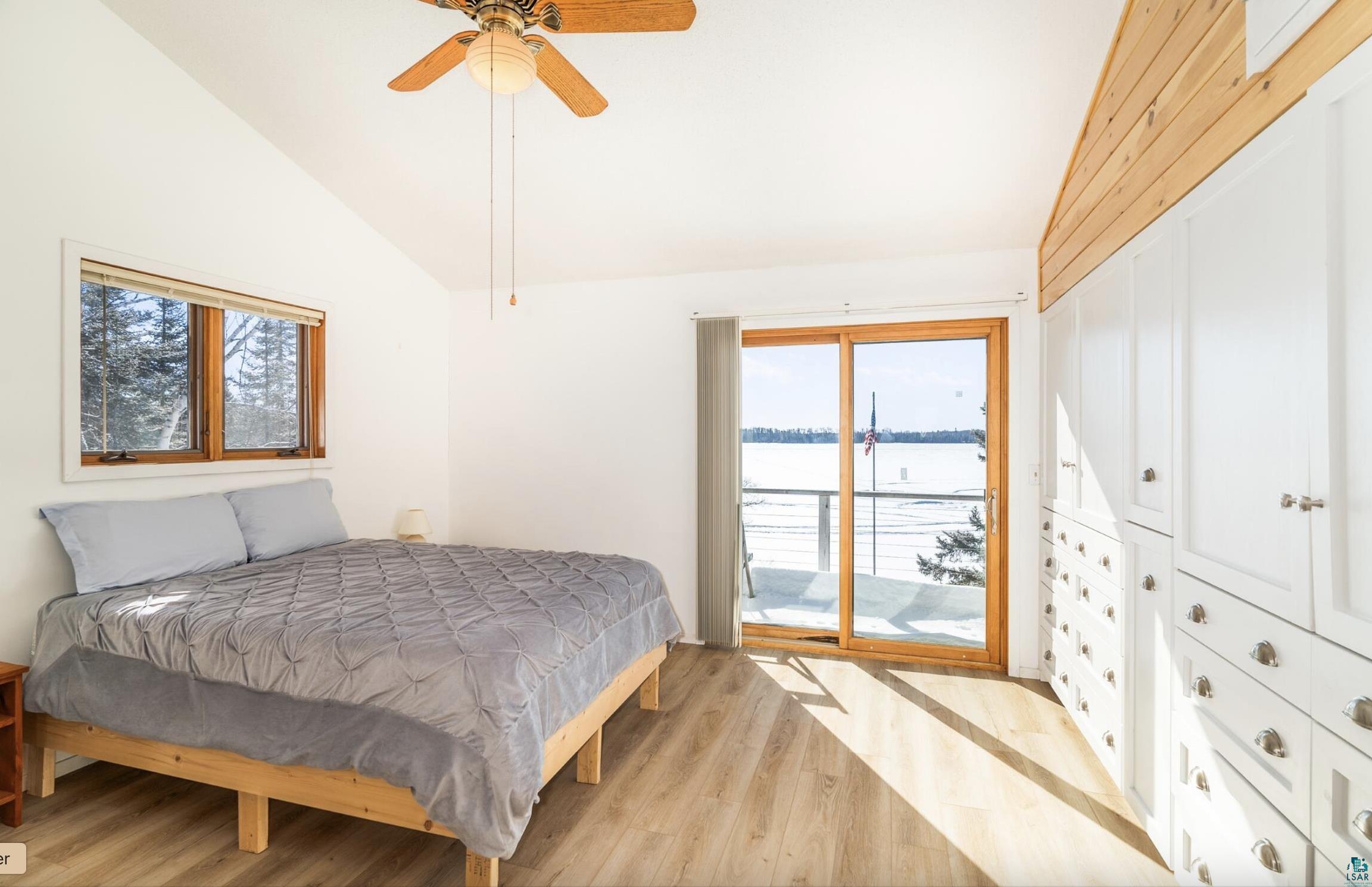 1480 Devil Track Road Grand Marais, MN 55604 - Photo 23 of 38 Bedroom featuring vaulted ceiling, balcony, with a lake view.