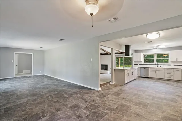 a view of a kitchen with a sink and cabinets