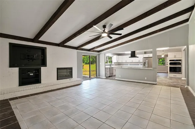 a view of a kitchen with a sink and a fireplace