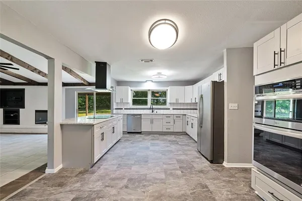 a kitchen with white cabinets and white appliances