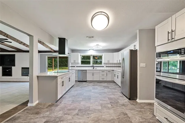 a kitchen with white cabinets and white appliances