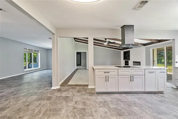 a kitchen with white cabinets and appliances