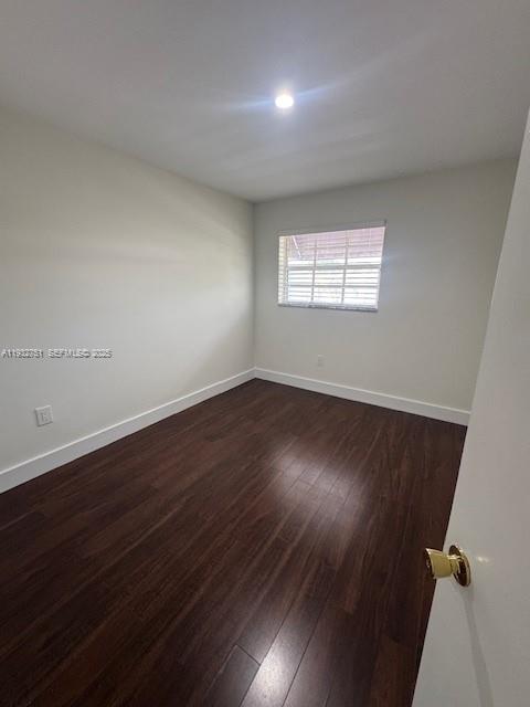 10351 Southwest 154th Place, Unit 68 Miami, FL 33196 - Photo 12 of 13 an empty room with wooden floor and windows