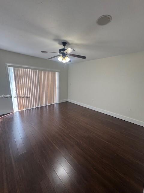 10351 Southwest 154th Place, Unit 68 Miami, FL 33196 - Photo 7 of 13 a view of an empty room with wooden floor and a window