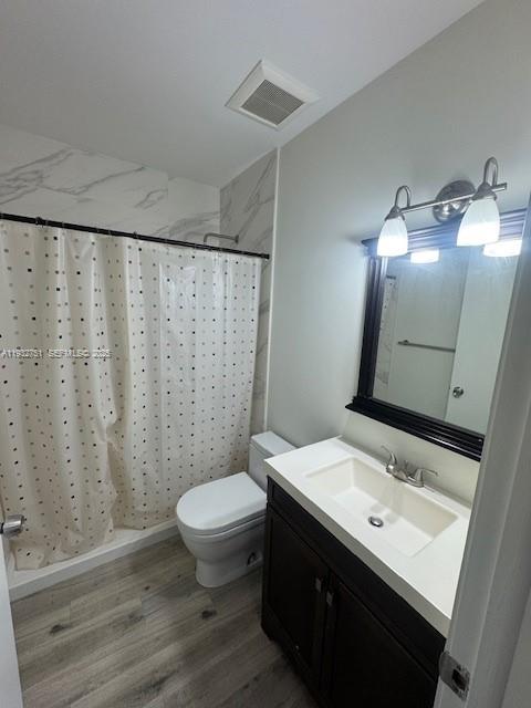 10351 Southwest 154th Place, Unit 68 Miami, FL 33196 - Photo 10 of 13 a bathroom with a sink a toilet a mirror and shower