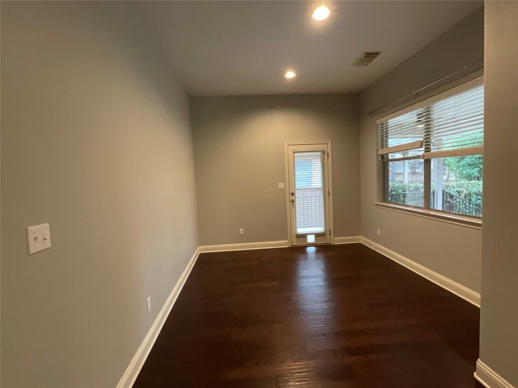 3928 Crest Lane Round Rock, TX 78681 - Photo 12 of 39 an empty room with wooden floor and windows