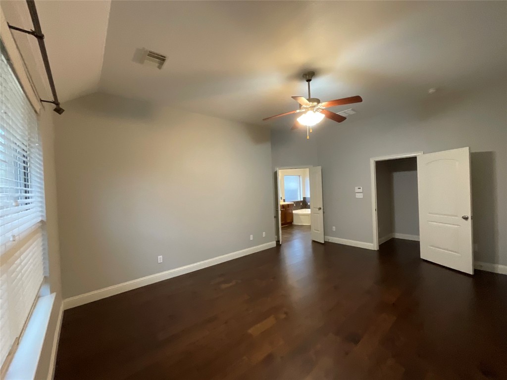 3928 Crest Lane Round Rock, TX 78681 - Photo 20 of 39 an empty room with wooden floor ceiling fan and window