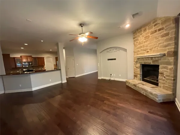 a view of a kitchen with a sink and a fireplace