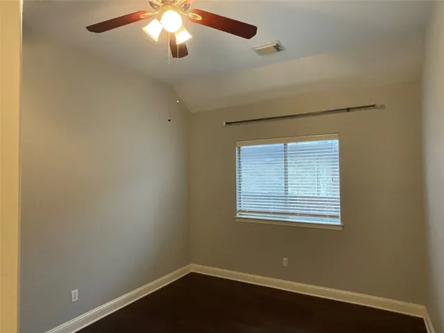 a view of a hallway with wooden floor and walls