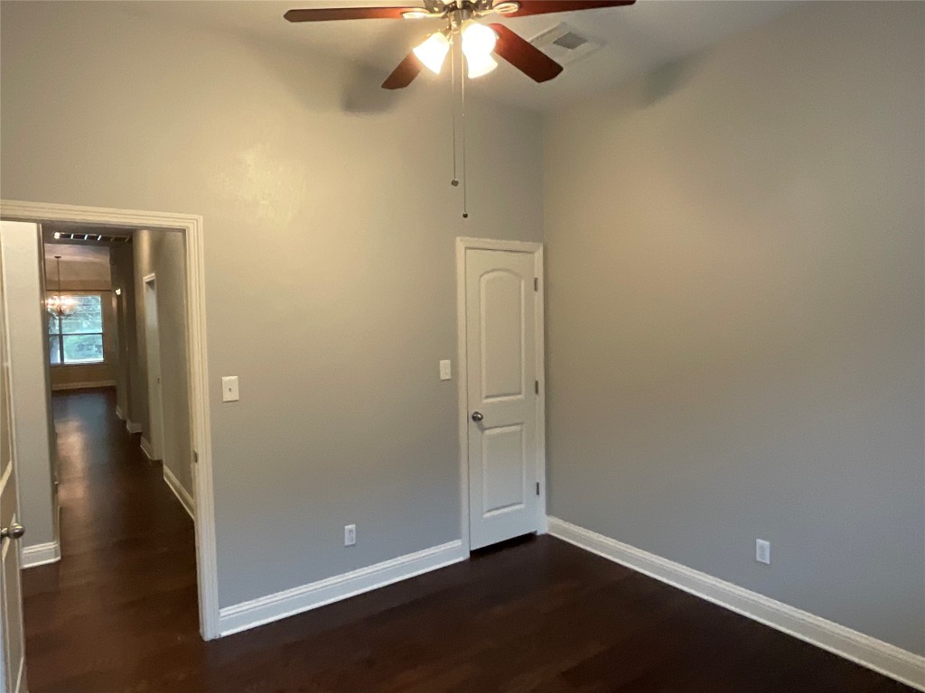 3928 Crest Lane Round Rock, TX 78681 - Photo 30 of 39 an empty room with wooden floor and chandelier fan