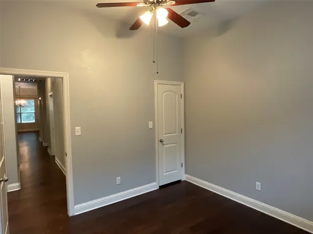 a view of a hallway with wooden floor and walls