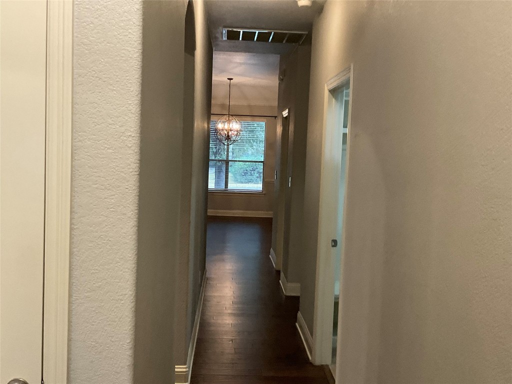 3928 Crest Lane Round Rock, TX 78681 - Photo 31 of 39 a view of a hallway with wooden floor and walls