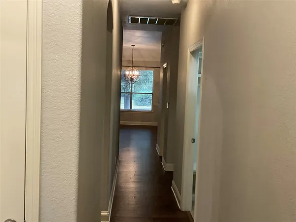 an empty room with windows and cabinet