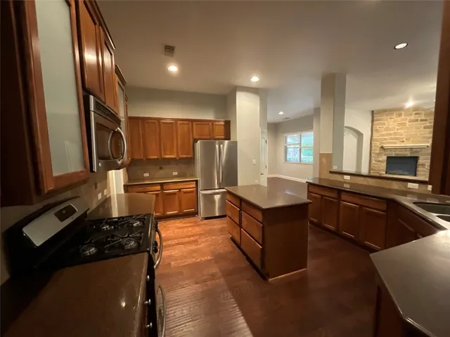 a kitchen with stainless steel appliances granite countertop a stove and a refrigerator