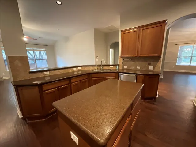 a kitchen with a sink appliances and cabinets