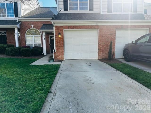 3406 Summerfield Ridge Lane, Unit 17 Matthews, NC 28105 - Photo 2 of 27 a front view of a house with a yard and garage