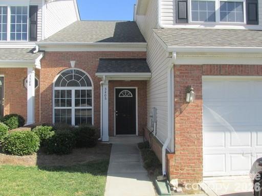 3406 Summerfield Ridge Lane, Unit 17 Matthews, NC 28105 - Photo 3 of 27 a front view of a house with a garden