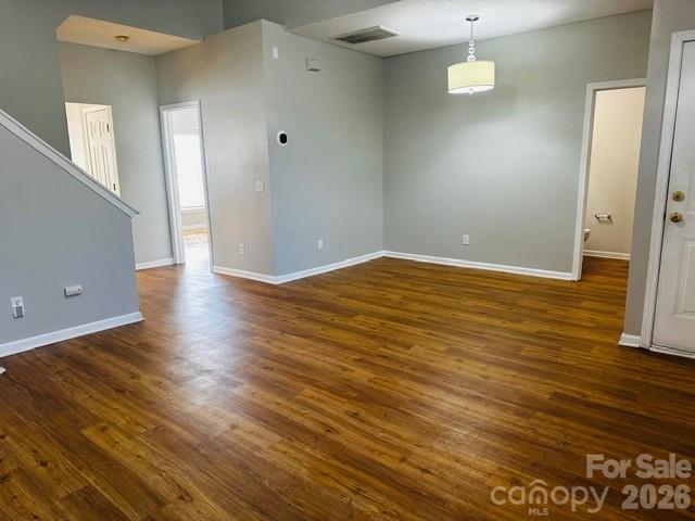 3406 Summerfield Ridge Lane, Unit 17 Matthews, NC 28105 - Photo 8 of 27 an empty room with wooden floor and windows