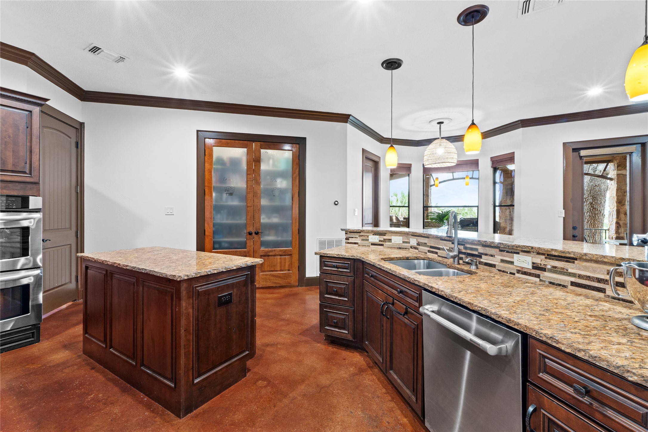 8211 Moon Rise Trail Jonestown, TX 78645 - Photo 16 of 34 Kitchen opens to the breakfast nook and features a spacious double door pantry.