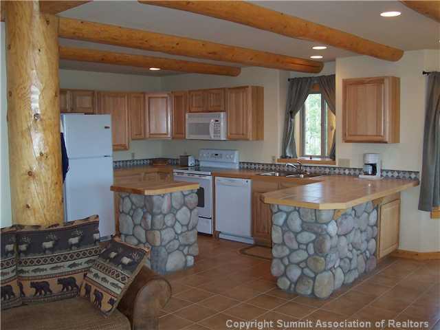 63 Osprey Road Como, CO 80432 - Photo 3 of 19 a kitchen with stainless steel appliances granite countertop a sink stove and refrigerator