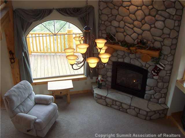 63 Osprey Road Como, CO 80432 - Photo 6 of 19 a living room with furniture a fireplace and a large window