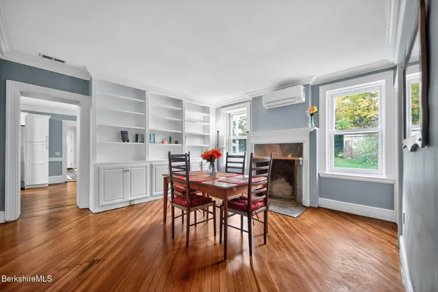 a dining room with furniture and wooden floor