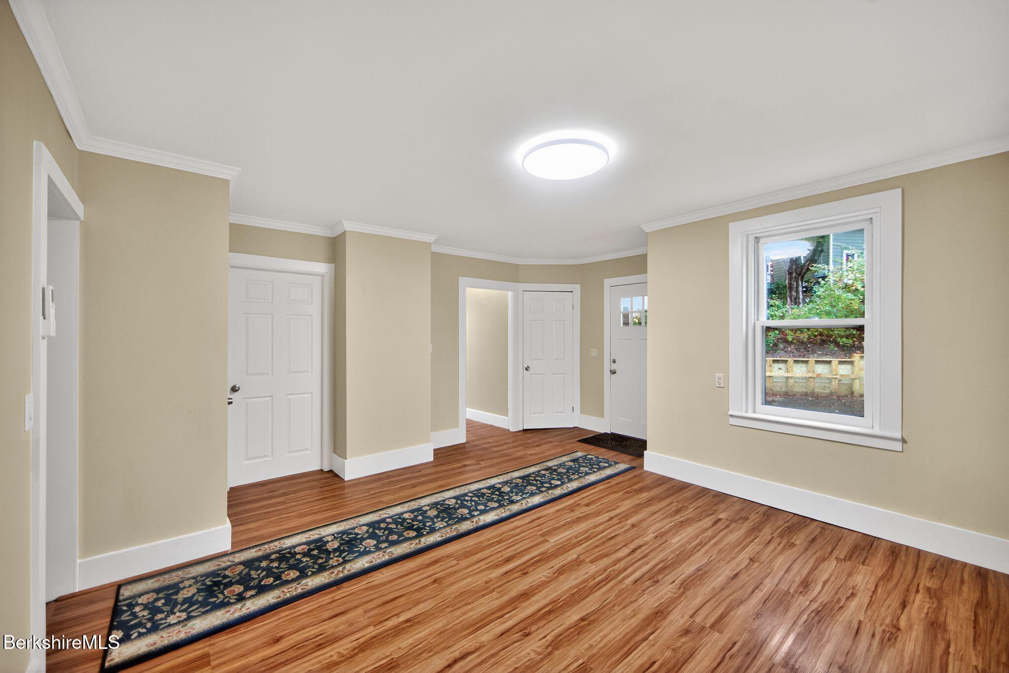 103 Holmes Road Hinsdale, MA 01235 - Photo 17 of 30 a view of an empty room with wooden floor and a window