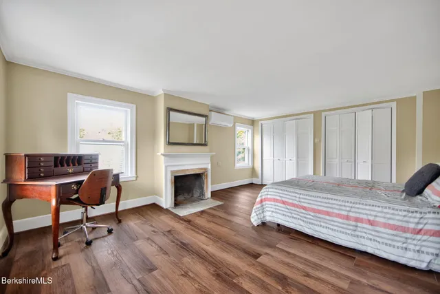 a bedroom with a bed and a fireplace