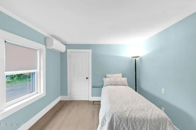 a bedroom with a bed and window