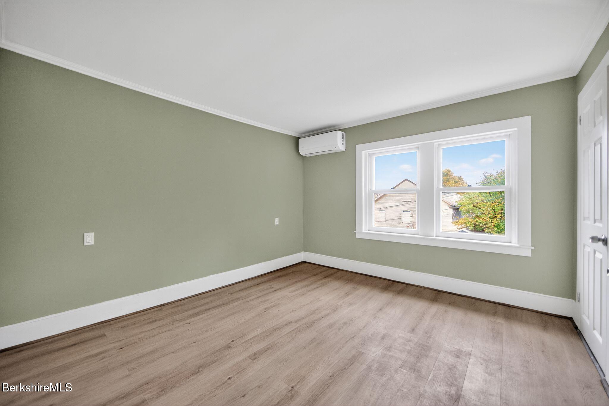 103 Holmes Road Hinsdale, MA 01235 - Photo 23 of 30 an empty room with wooden floor and windows