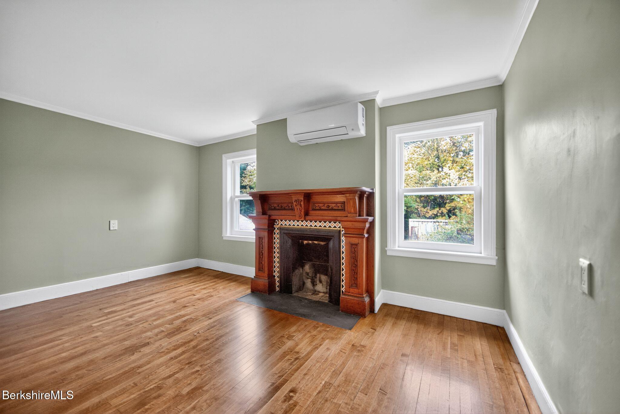 103 Holmes Road Hinsdale, MA 01235 - Photo 24 of 30 an empty room with fireplace and wooden floor