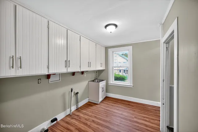 a view of an empty room with closet and a window