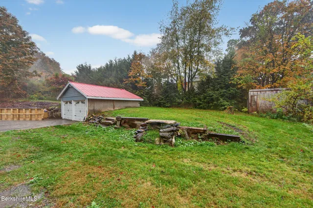 a backyard of a house with table and chairs
