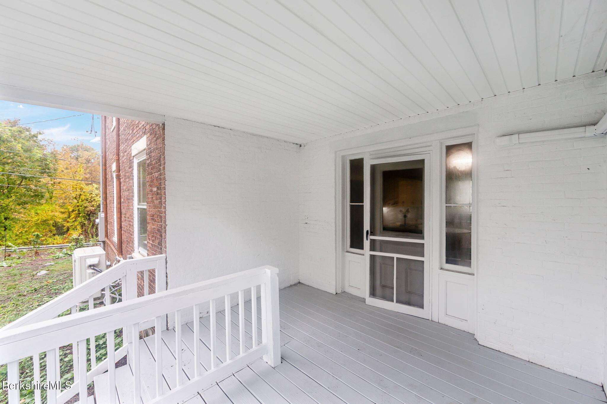 103 Holmes Road Hinsdale, MA 01235 - Photo 4 of 30 a view of an empty room with a window and wooden floor