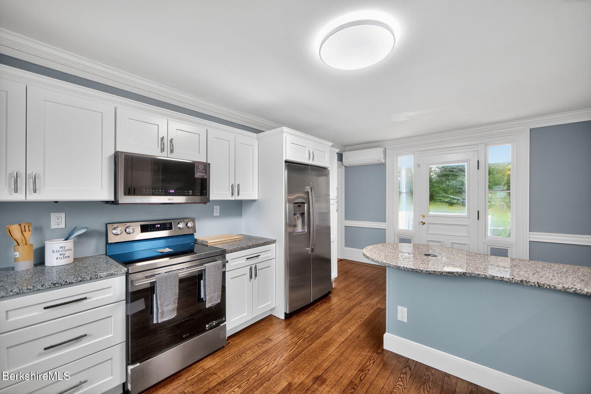 103 Holmes Road Hinsdale, MA 01235 - Photo 5 of 30 a kitchen with stainless steel appliances granite countertop a stove a sink and a refrigerator