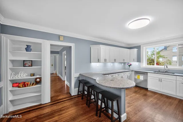 a kitchen with granite countertop chair and center island
