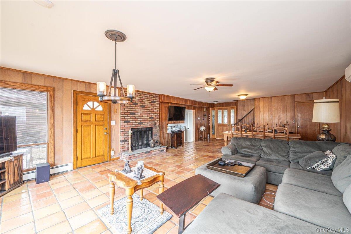 2 Shore Road East Patchogue, NY 11772 - Photo 17 of 34 a living room with furniture a fireplace and a chandelier