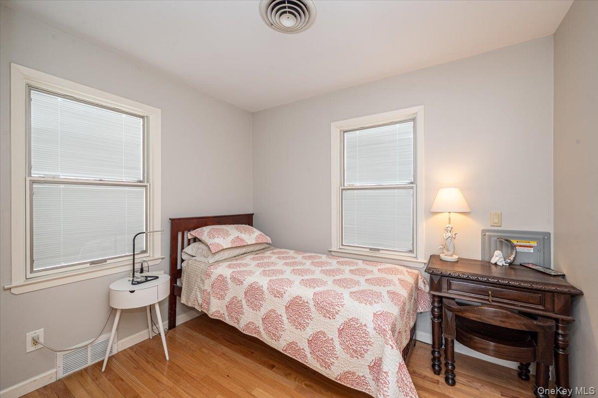2 Shore Road East Patchogue, NY 11772 - Photo 24 of 34 a bedroom with a bed and a window