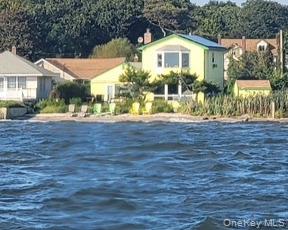 2 Shore Road East Patchogue, NY 11772 - Photo 8 of 34 a front view of a house with a yard