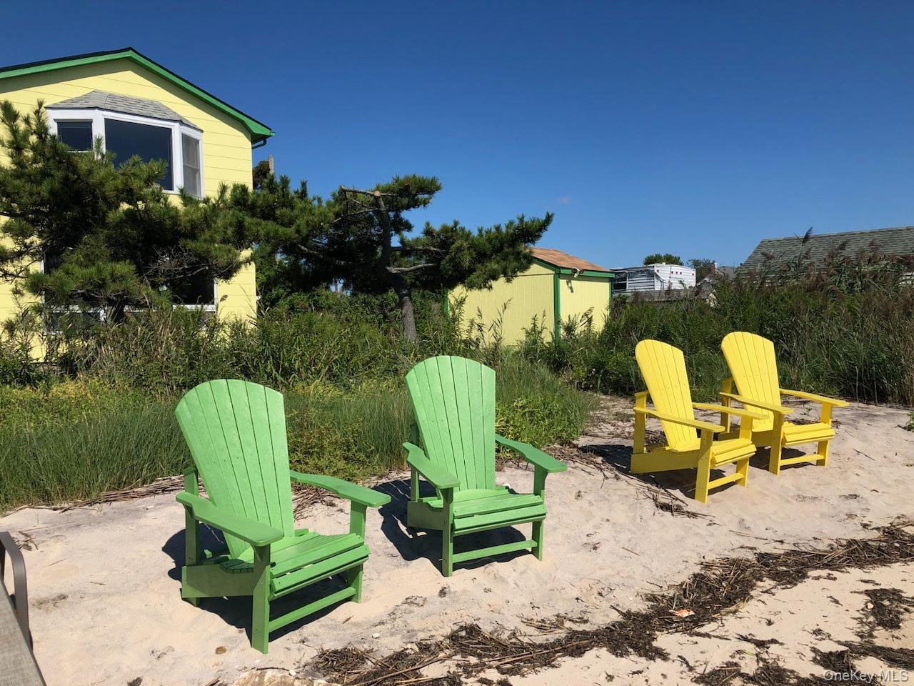 2 Shore Road East Patchogue, NY 11772 - Photo 9 of 34 a view of a chair and table in backyard