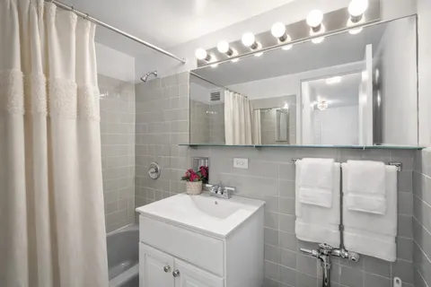 a bathroom with a sink vanity and a mirror