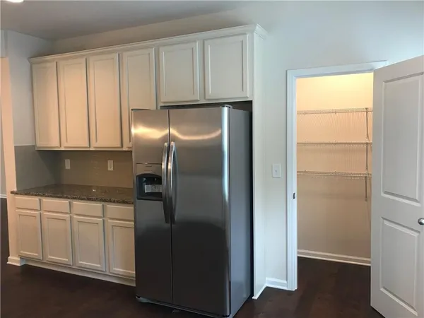 a kitchen with metallic refrigerator freezer and a dishwasher