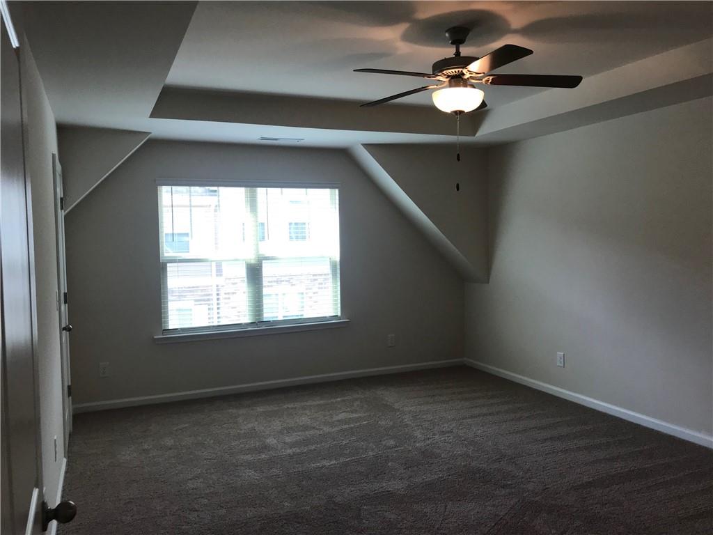 3844 Equity Lane Powder Springs, GA 30127 - Photo 18 of 38 en empty room with windows and ceiling fan