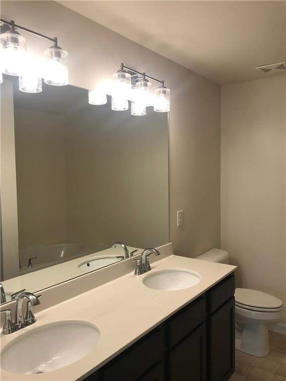 3844 Equity Lane Powder Springs, GA 30127 - Photo 21 of 38 a bathroom with a sink and mirror