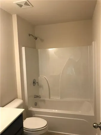 a bathroom with a toilet and a bathtub