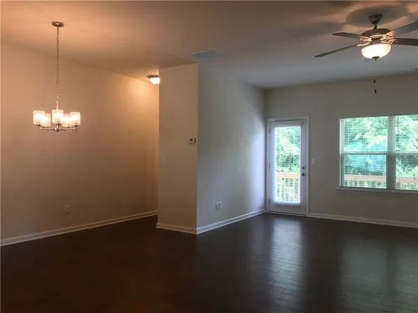 a view of a room with wooden floor and windows